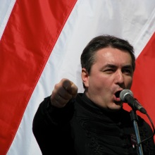 Reformed pastor Loránt Hegedűs Jr. speaks in front of an Árpád-Striped Flag during an anti-government rally on the March 15 national holiday (5/15/2008).