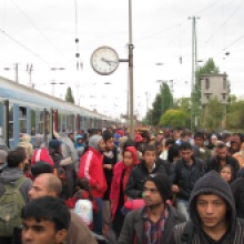 Migrants walk down platform at Hegyeshalom railway station.
